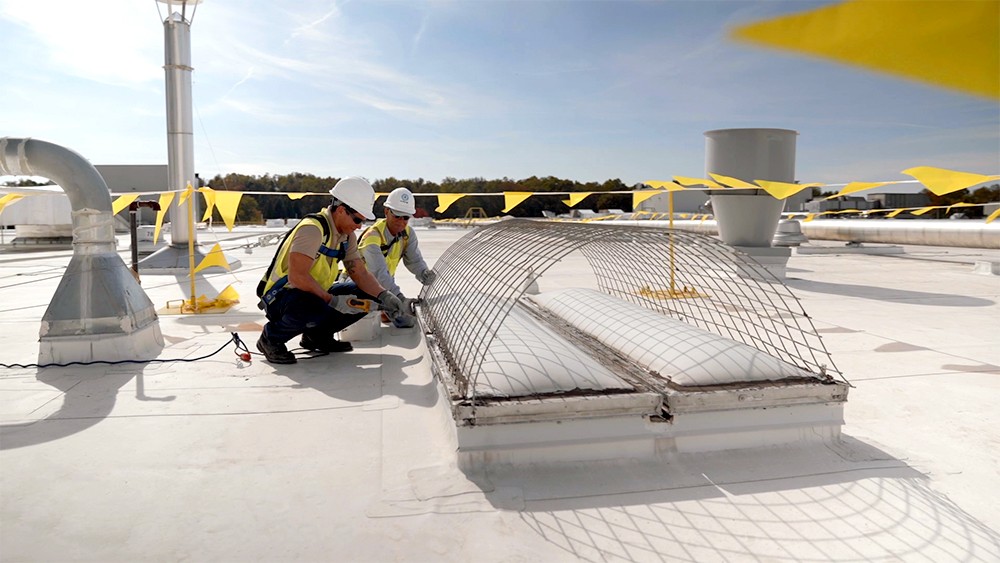 two roofers installing equipment