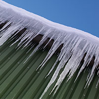 ice on commercial roof posing danger for pedestrians and cars below