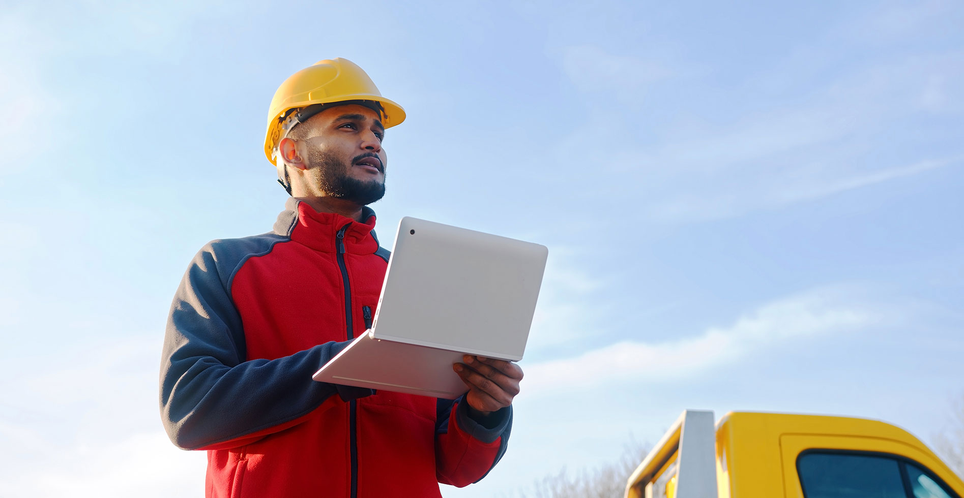 engineer with a laptop looking at the roof