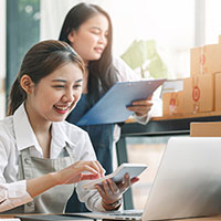 two female business owners smiling at work