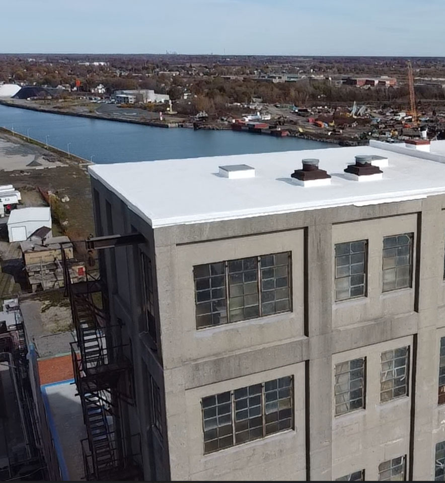 A building by the lake with TPO roof