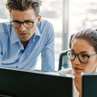 two office workers looking at the computer