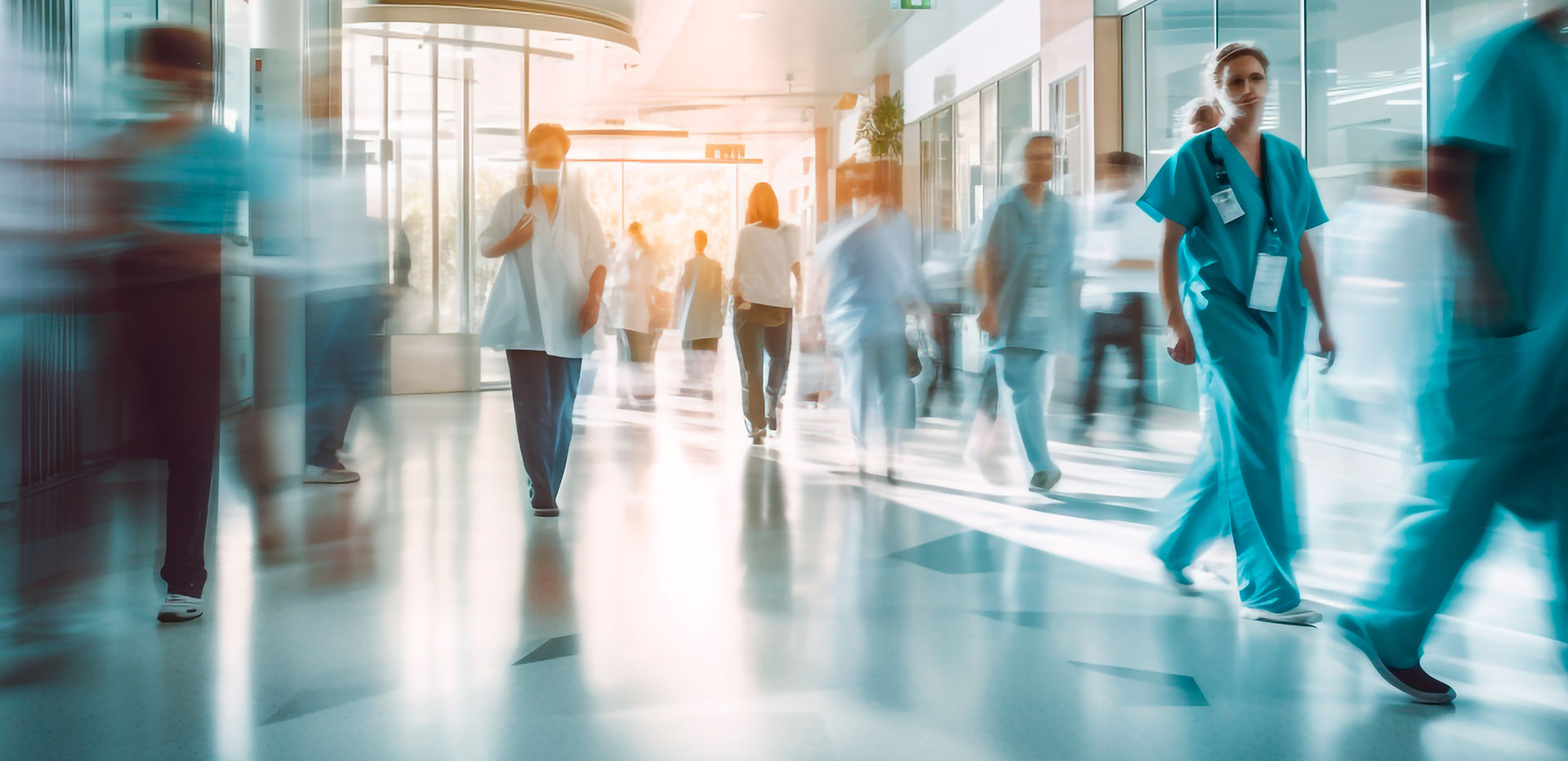 people walking through a hospital corridor