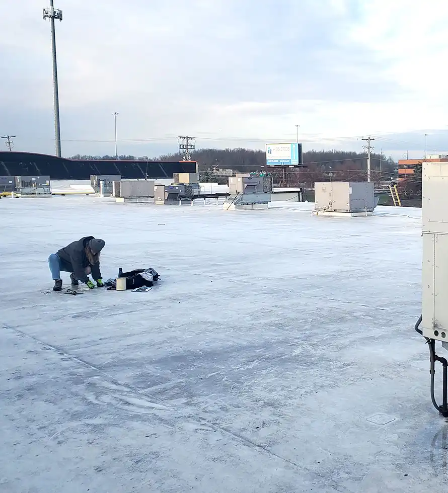 female roof inspector taking a roof core