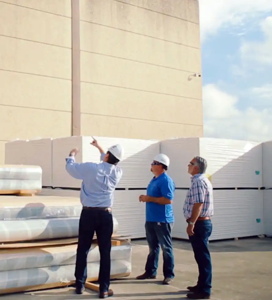 roofing professionals looking at facility's roof