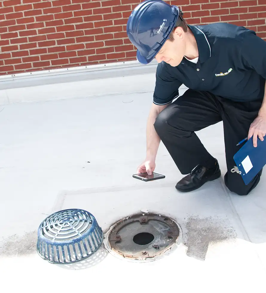 commercial roofing techs taking the core during roof inspection